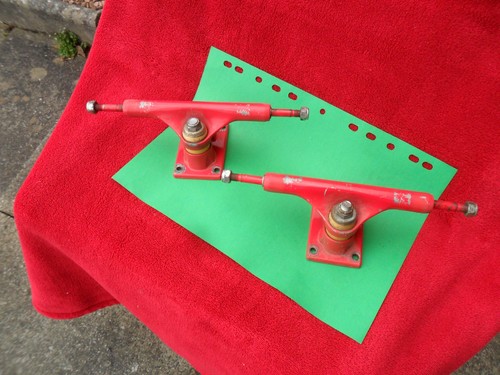 Red pair skateboard trucks - red,