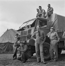 US Army troops seated & around