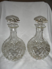 A PAIR OF ANTIQUE HEAVY CUTGLASS MUSICAL DECANTERS.