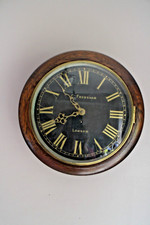An oak cased fusee wall clock with the black dial inscribed in gilt C Frodsham,