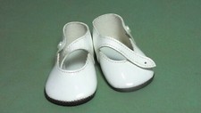 Pair of white doll shoes