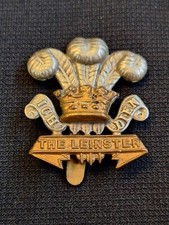 THE LEINSTER REGIMENT ROYAL CANADIANS CAP BADGE ON SLIDER CURLY SCROLL TYPE