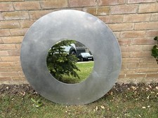 Circular Mirror statement feature with metallic frame ideal for above a mantel