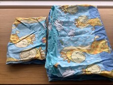 Two cot bedding sets with a giraffe design on