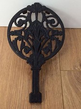 Ornate cast iron trivet for