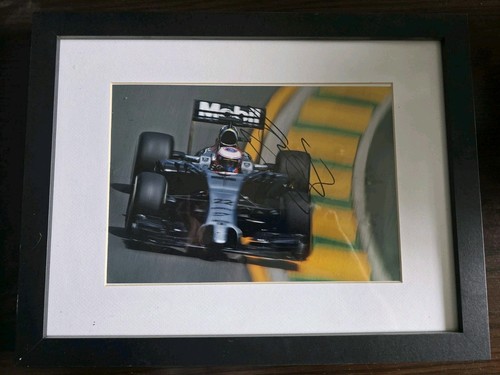 Signed framed photo with - signed,