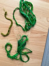 Oddments of bright green yarn