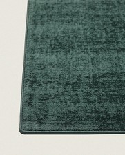 Designer Rols Luna Rug in Emerald Green with whipped edge - sustainable design.