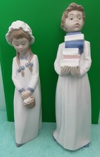 2 Nao by Lladro "BOY CARRING BOOKS AND GIRL WITH BASKET"