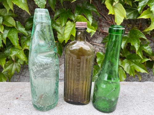 Three antique glass bottles.