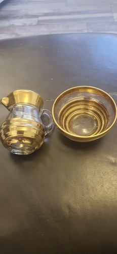 Small gold glass jug and - glass,