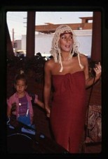 Cher in exotic red off shoulder dress wig with Chastity Original Transparency