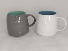 Pair Of Large Minimalist Tea Coffee Mugs With Embossed Face Design Grey White