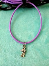 2 Plastic purple bracelets with teddy pendants.