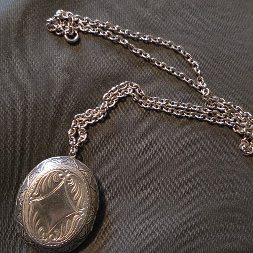 Silver tone engraved oval - tone,