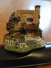 ornamental cottage with white picket fence