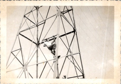 Teen boy climbs lattice tower - teen,