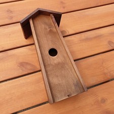 Wooden feeding station for birds, in brown color