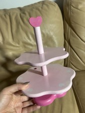 Girls play two-tier wooden cupcake or dessert stand