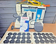 Toyota Model 2701 EC1 Series Sewing Machine with foot pedal and accessories.