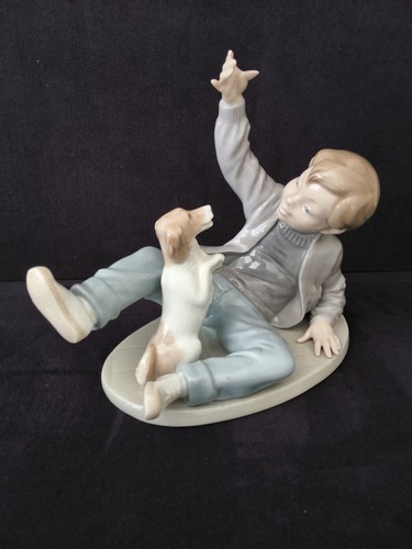 Nao lladro boy playing - by,