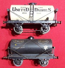 2 x VINTAGE O GAUGE WAGONS . ESSO TANK WAGON AND UNITED DAIRIES TANK WAGON.