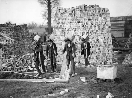 Four bricklayers work - at,