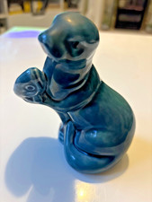 Poole seal holding fish colour green