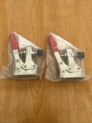 Pair holding down - of,