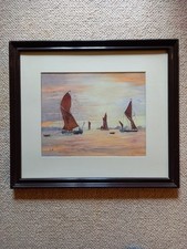 Framed watercolour of sailing vessels in the evening light - L Harding