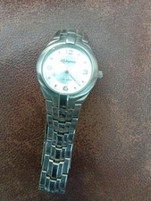 This is a silver-toned Kahuna women's watch with a stainless steel bracelet and