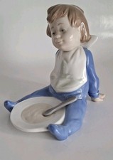 Nao Lladro "I'm Full" Baby Boy with bib and plate.