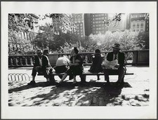 Photo:People sitting on a park