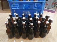 Vintage brown flip-top Grolsch bottles in milk crate, ideal for home brewing