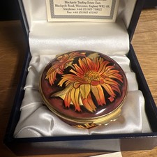 A Moorcroft Enamel Pill Box. Sunflower Pattern. Boxed. Limited edition 27/100 