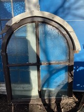 Arched wire mesh safety glass window panel