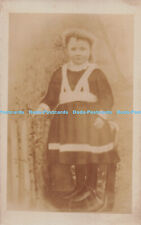 R286246 Little girl with curly hair and dress standing on chair G Wade