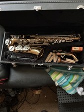 Earlham alto saxophone with mouth piece, neck strap, reeds and hard case. 