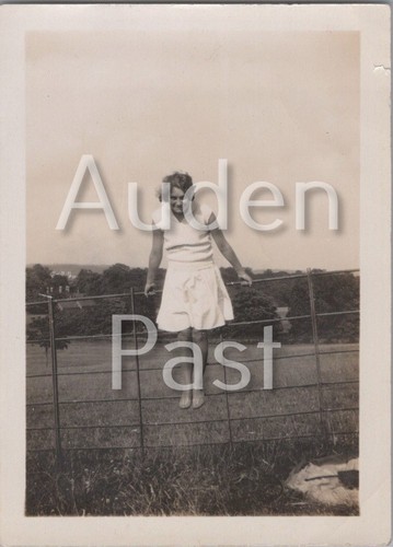 Woman standing field fence - standing,