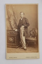 CDV OF A VICTORIAN MAN BETWEEN STUDIO PROPS, BY MAYALL OF LONDON & BRIGHTON