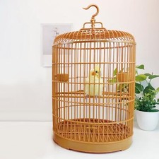 Round bird cage with - bird, standing