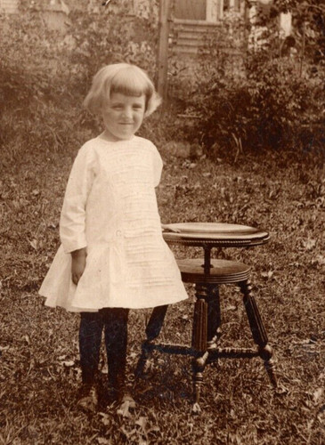 Rppc young girl stands beside - rppc,
