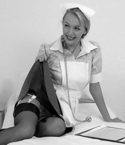 1960s nurse holding skirt - 1960s, up