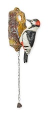 A cast iron woodpecker door