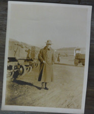 Vintage photo Man in Uniform Standing Near Military Trucks Mounty Hat?