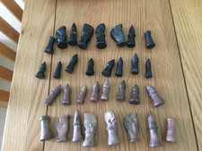 VINTAGE CHESS SET CARVED SOAPSTONE OF AFRICAN FIGURES IN VGC. NO BOARD