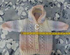 Baby girl's hand knitted cable
