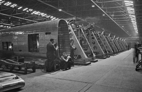 Three aircraft workers work