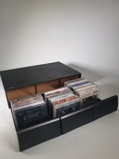 vintage cassette tape storage unit with some audio cassette tapes