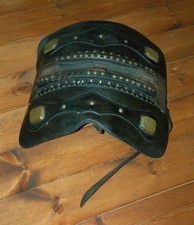 An antique leather heavy horse cart saddle, pad, some brasswork